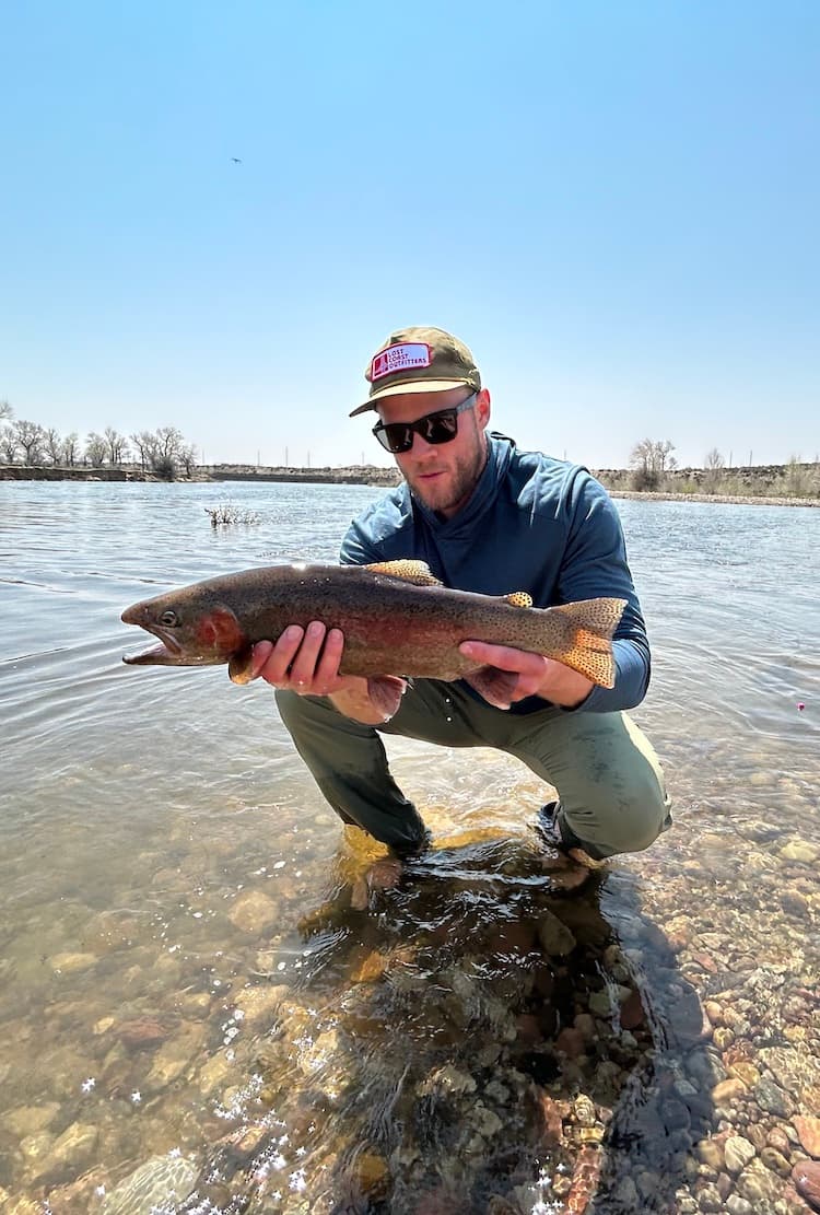 picture of colten holding a rainbow trout